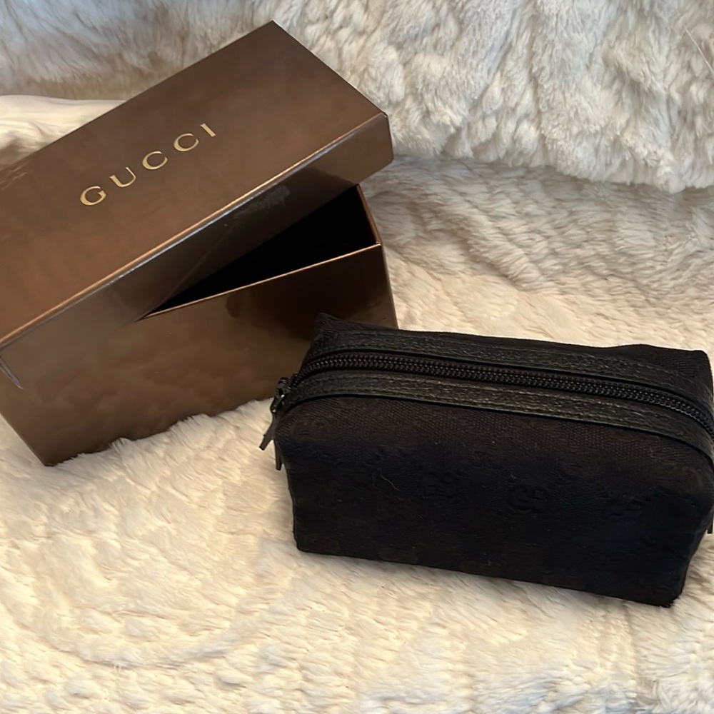Gucci fabric cosmetic bag with GG monograms.